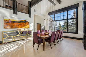 Dining area with lofted ceiling and wood finished floors