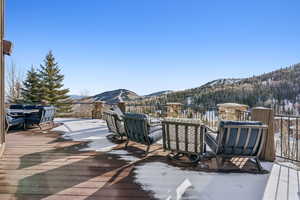 Snow covered deck with a mountain view