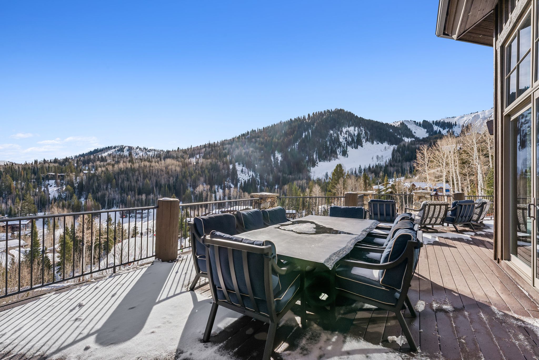 Wooden terrace featuring outdoor dining area and a mountain view