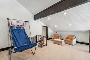Sitting room featuring vaulted ceiling with beams, carpet floors, wooden ceiling, recessed lighting, and an upstairs landing