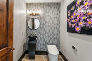 Bathroom with baseboards and tile walls