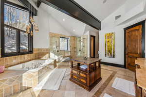 Full bath featuring a stall shower, vaulted ceiling, a bath, and recessed lighting
