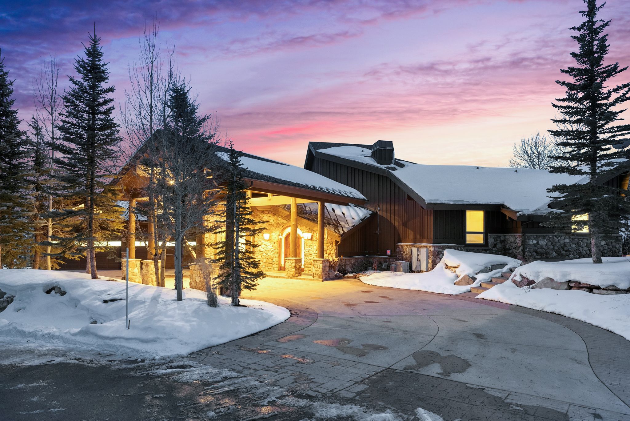 View of front of house featuring stone siding and board and batten siding
