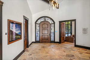 Entryway featuring stone floors and vaulted ceiling