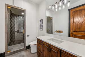 Full bathroom with a shower stall, vanity, and light tile patterned floors