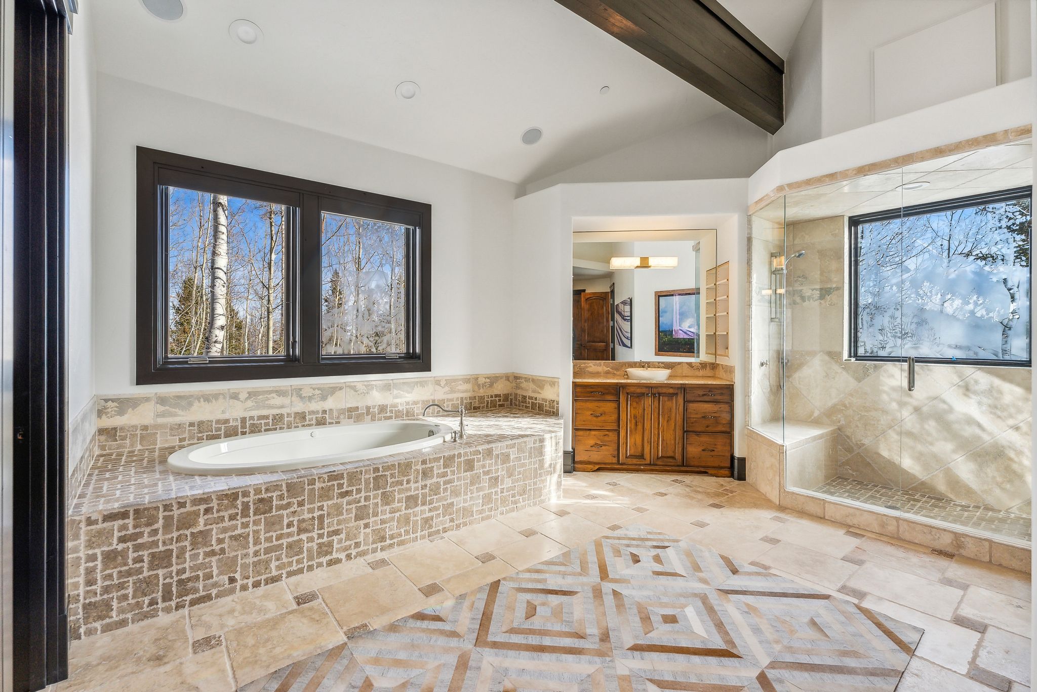 Full bath featuring vanity, a shower stall, a garden tub, and lofted ceiling with beams