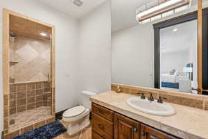 Ensuite bathroom with a stall shower, vanity, recessed lighting, and light tile patterned floors