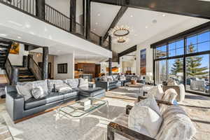 Living room with a high ceiling and a chandelier