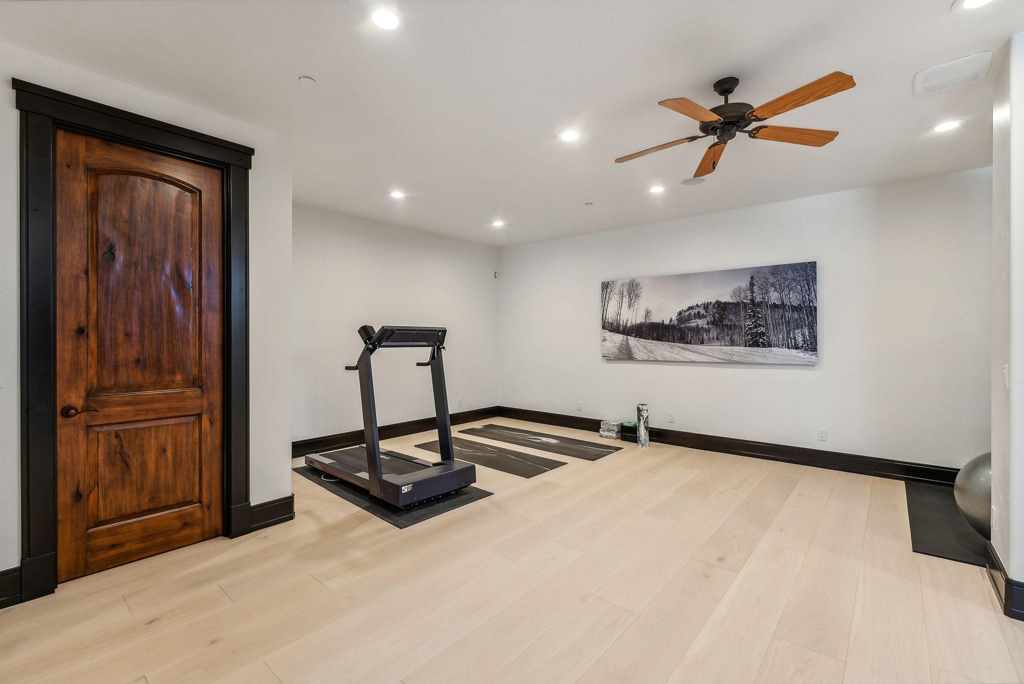 Workout area featuring light wood-type flooring, recessed lighting, and ceiling fan