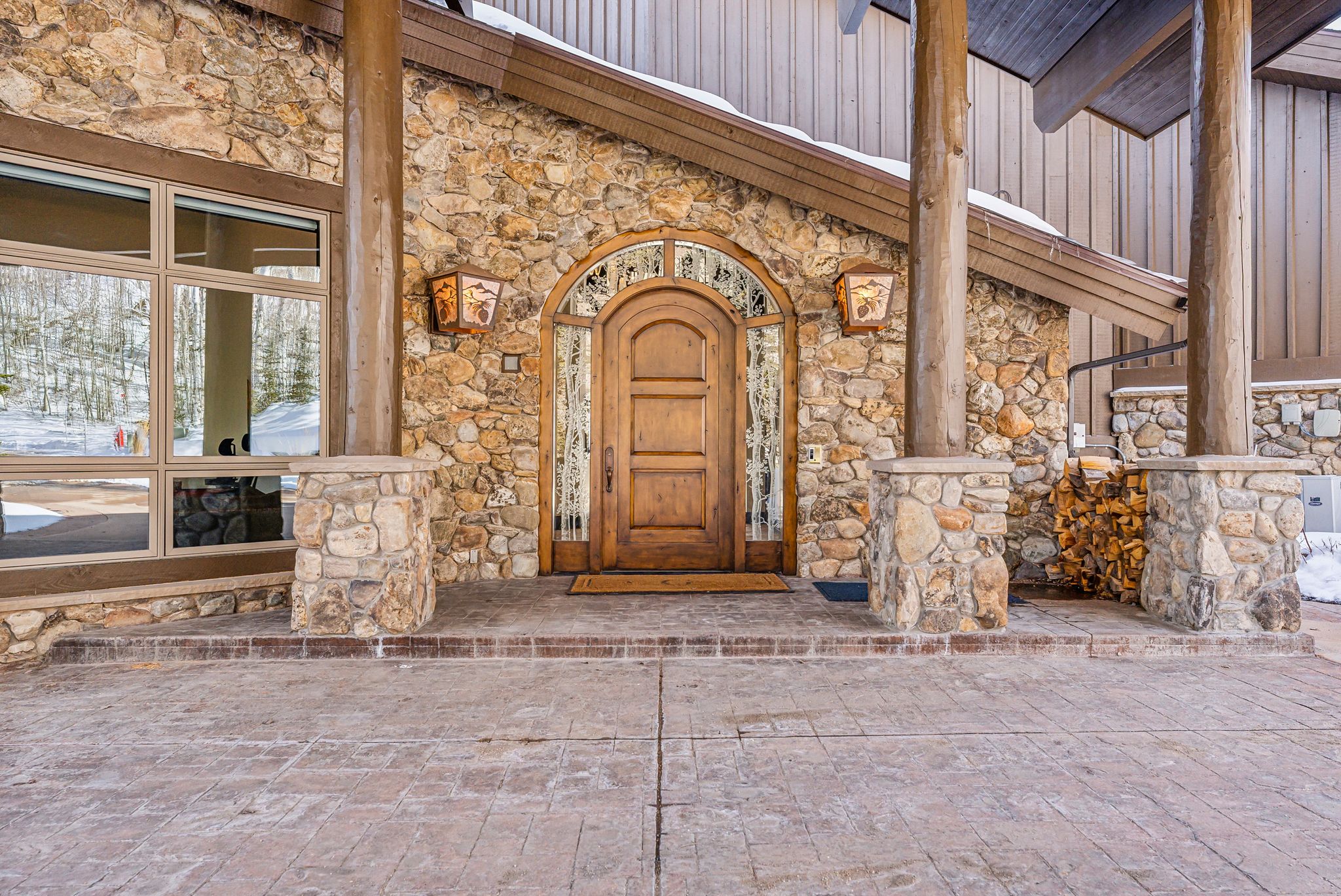 View of exterior entry featuring stone siding
