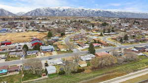 Aerial overview of property's location with nearby suburban area and a mountainous background