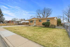 Single story home with brick siding, concrete driveway, and an attached carport