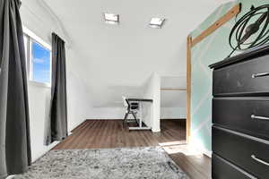 Interior space featuring light wood-style floors and vaulted ceiling