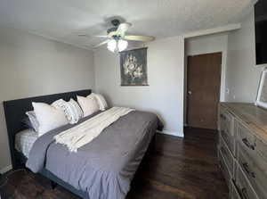 Bedroom with dark wood finished floors, ceiling fan, and a textured ceiling