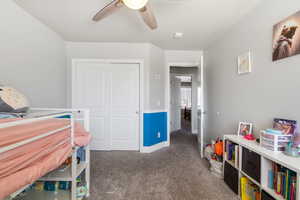 Bedroom featuring carpet floors, a closet, and a ceiling fan