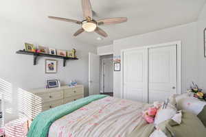 Bedroom featuring a closet and a ceiling fan