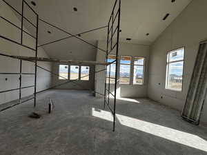 Interior space featuring lofted ceiling and multiple windows