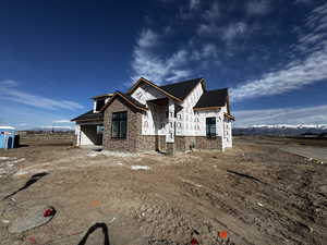 Property in mid-construction featuring a mountain view and brick siding