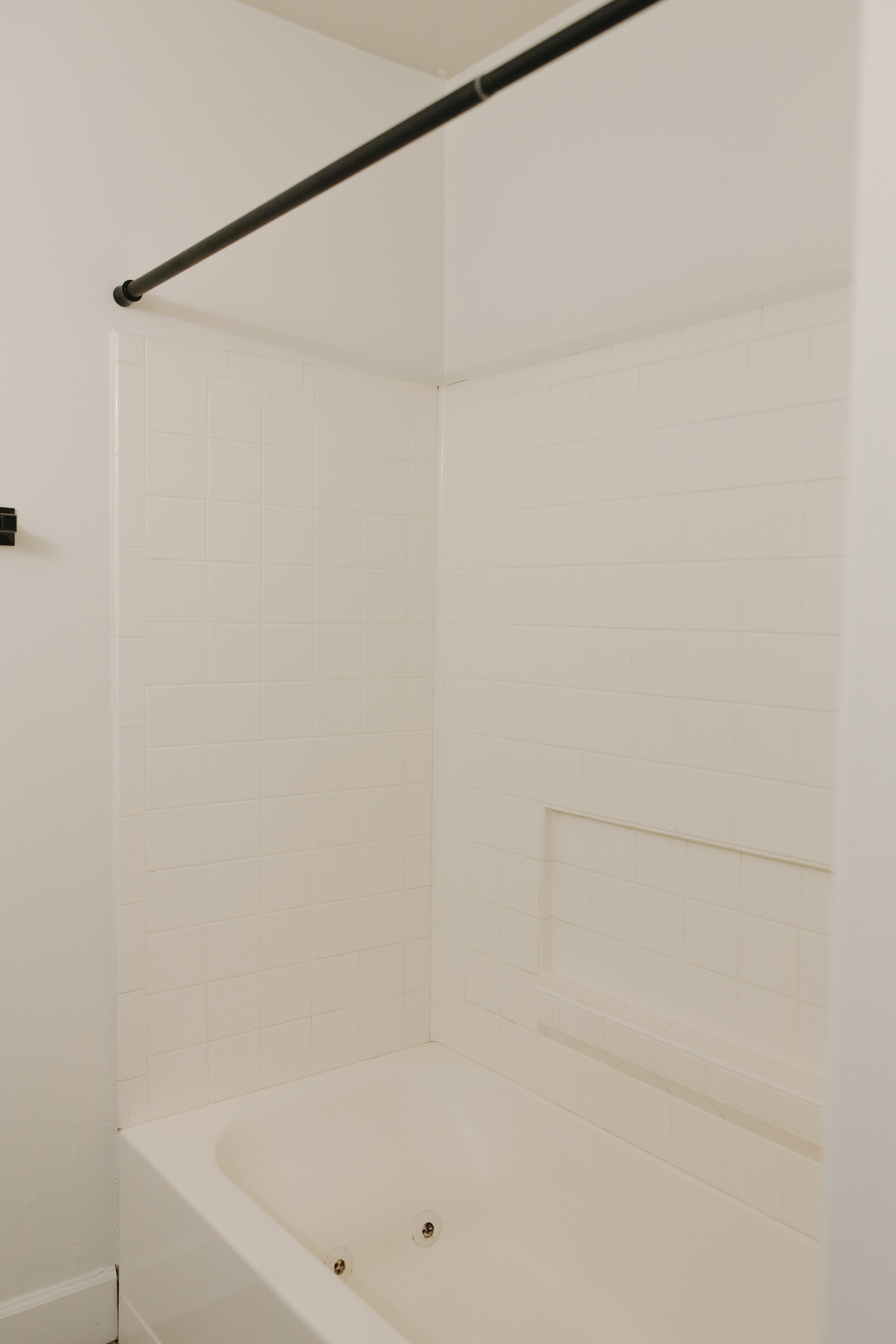 Bathroom with bathtub / shower combination and baseboards