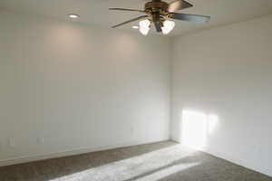 Empty room with a ceiling fan, carpet flooring, and recessed lighting