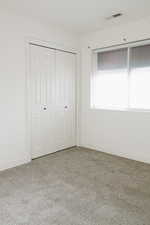 Unfurnished bedroom with carpet floors and a closet