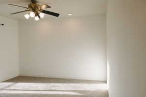 Spare room with recessed lighting, ceiling fan, and carpet