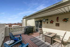 Deck featuring grilling area and outdoor dining area