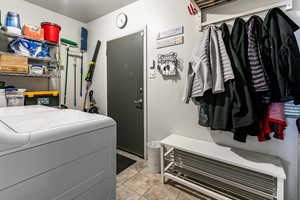 Laundry area with light tile patterned floors