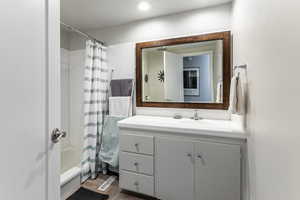 Full bathroom featuring vanity and shower / bath combo with shower curtain