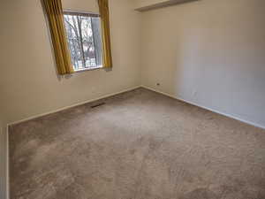 Unfurnished room featuring carpet flooring and baseboards