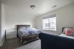 Bedroom featuring carpet flooring and baseboards