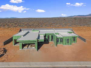 View of front of house featuring a desert view, a mountain view, and a patio area