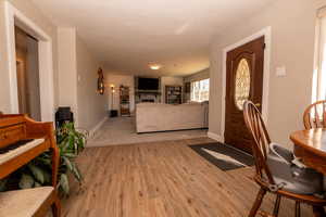 Entryway featuring a large fireplace and light wood finished floors