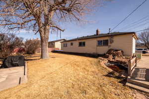 Rear view of property featuring a chimney