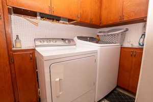 Laundry area with cabinet space and washing machine and dryer