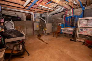 Unfinished below grade area with heating unit and water heater