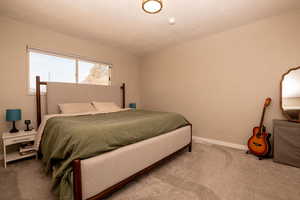Carpeted bedroom featuring baseboards