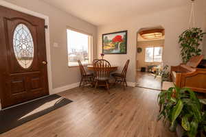 Entryway featuring light wood-style floors and arched walkways