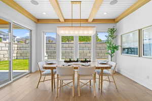 Dining space featuring light wood-style floors, beam ceiling, and a mountain view