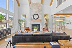 Living area with a fireplace, light wood-style floors, and plenty of natural light