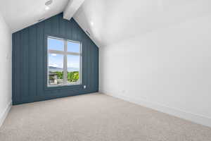 Bonus room with beamed ceiling, a mountain view, and carpet flooring