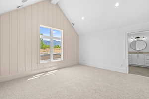 Additional living space with a mountain view, light colored carpet, recessed lighting, and beamed ceiling