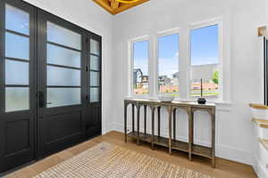 Foyer entrance with light wood finished floors