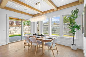 Sunroom with a mountain view and beamed ceiling
