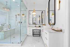 Full bathroom with a marble finish shower, vanity, light marble finish flooring, and recessed lighting