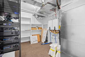 Utility room featuring tankless water heater