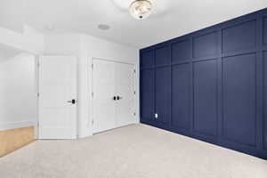 Unfurnished bedroom with a closet and carpet floors