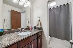 Bathroom featuring vanity and shower / bath combo