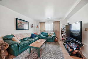 Living area featuring light wood-style flooring and baseboards