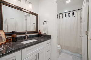 Full bathroom with vanity and shower / tub combo with curtain